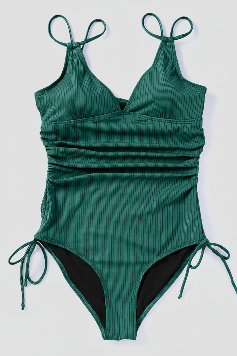 Green ribbed swimsuit with tie straps on a white background