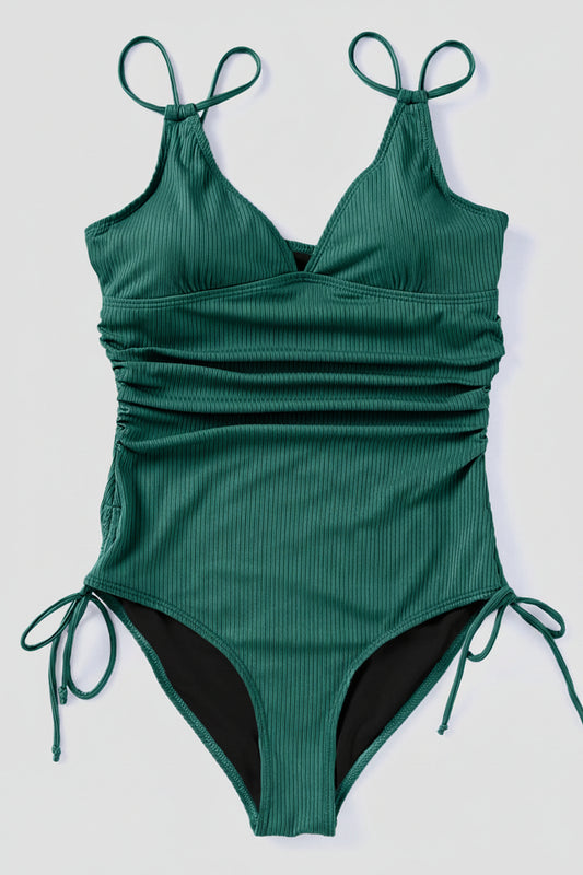 Green ribbed swimsuit with tie straps on a white background