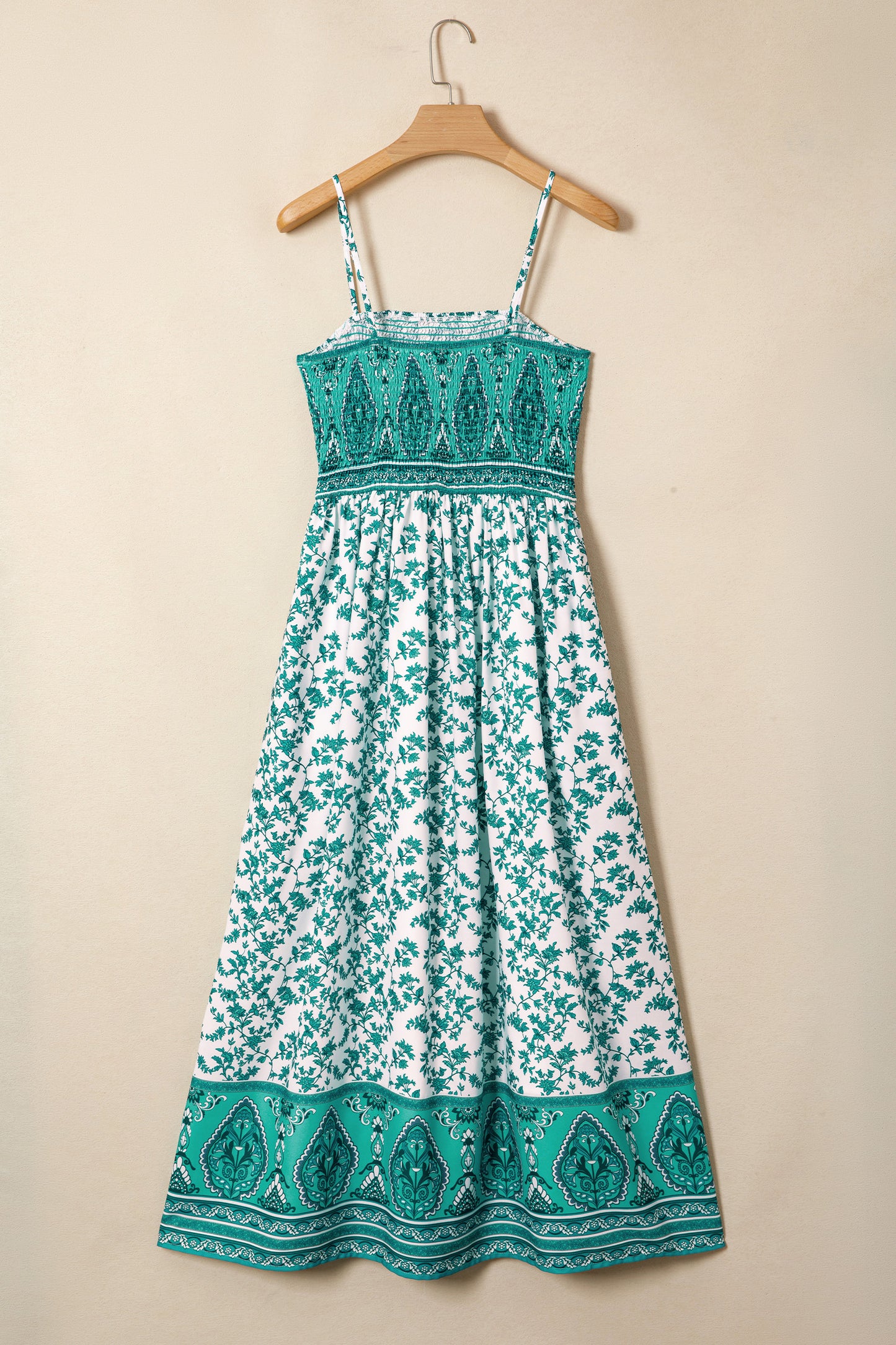 Green and white floral dress on a beige background